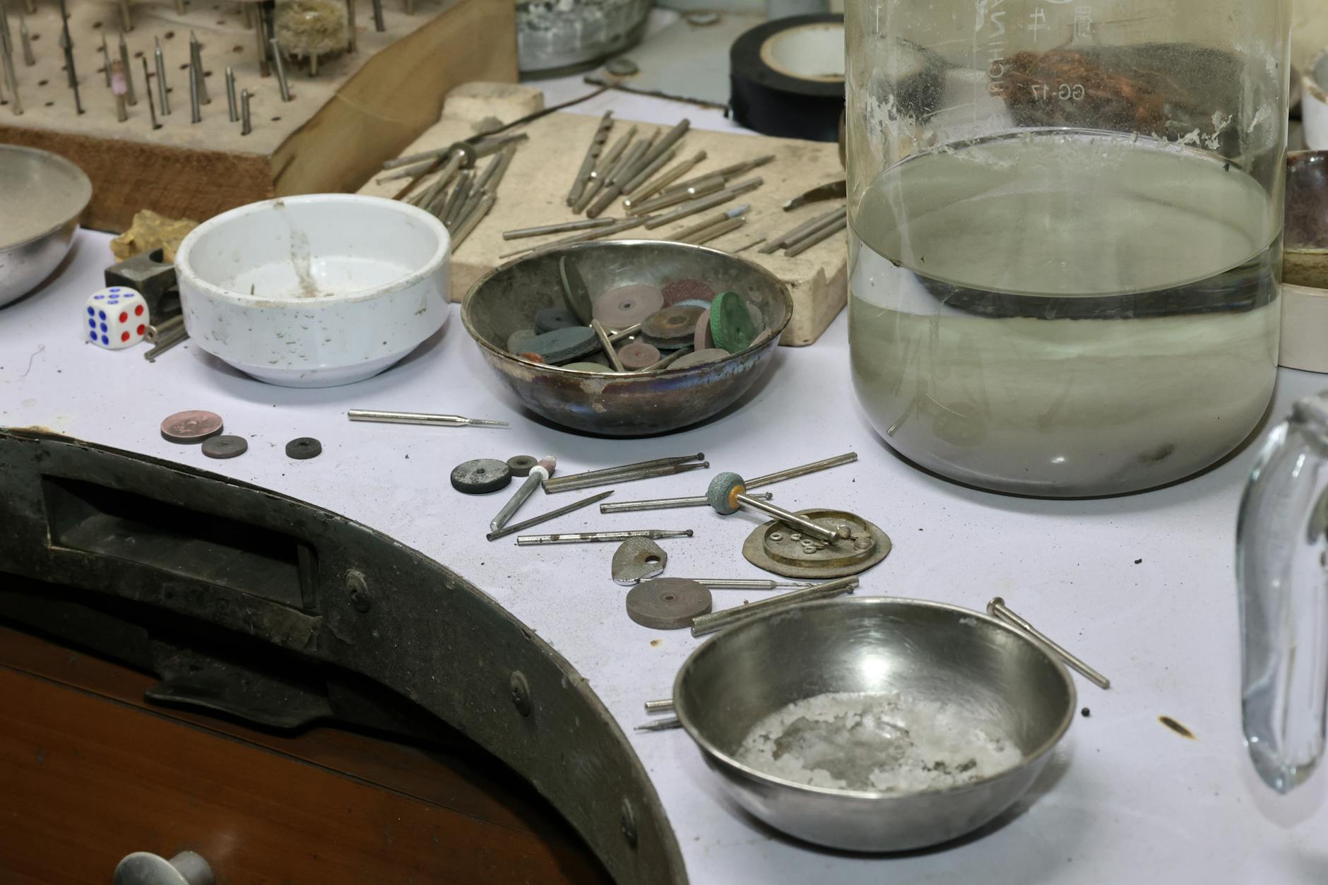 Kering Jewelry — A detailed view of a jeweler's workbench with various tools and materials for crafting and repair.