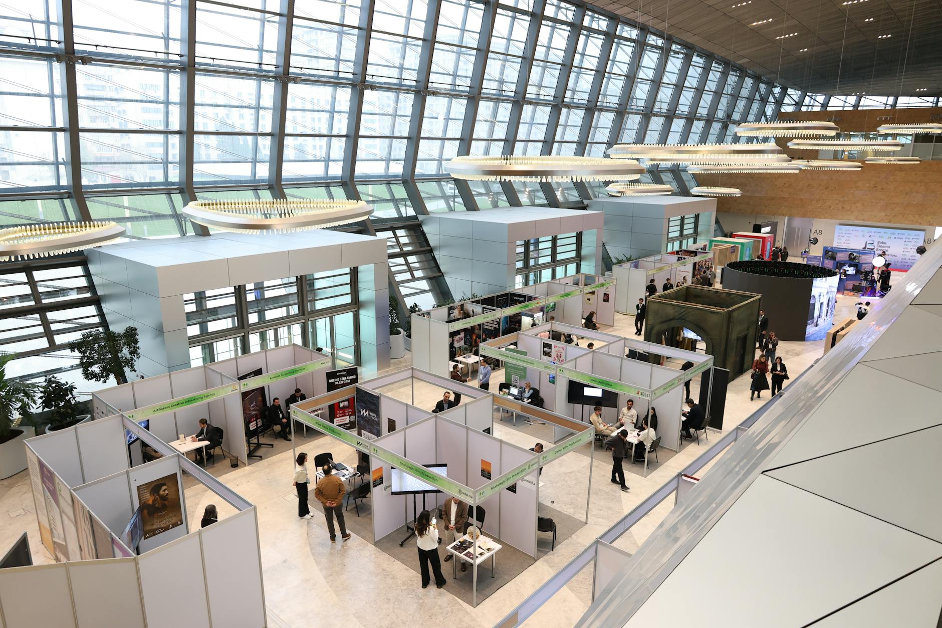 Cosmoprof buyer — A bustling trade show exhibition inside a modern hall with people networking and exploring booths.