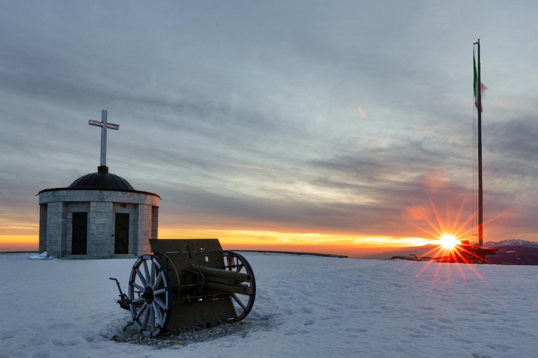 Festa della Liberazione — Stunning sunset view of Monte Grappa with a military memorial, snow, and Italian flag.