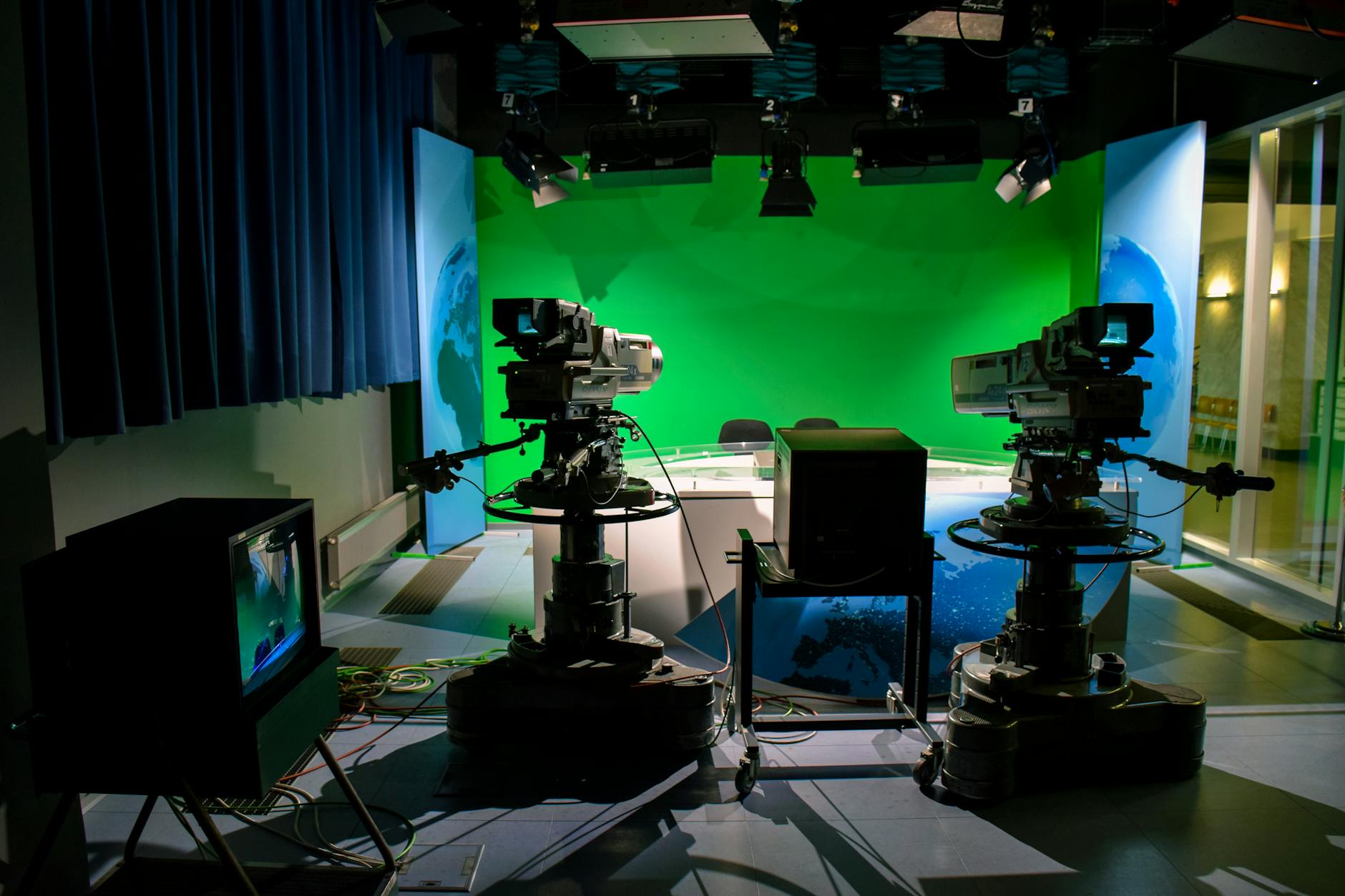 Sky TG24 Business — A TV studio setup featuring cameras and a green screen for production purposes.
