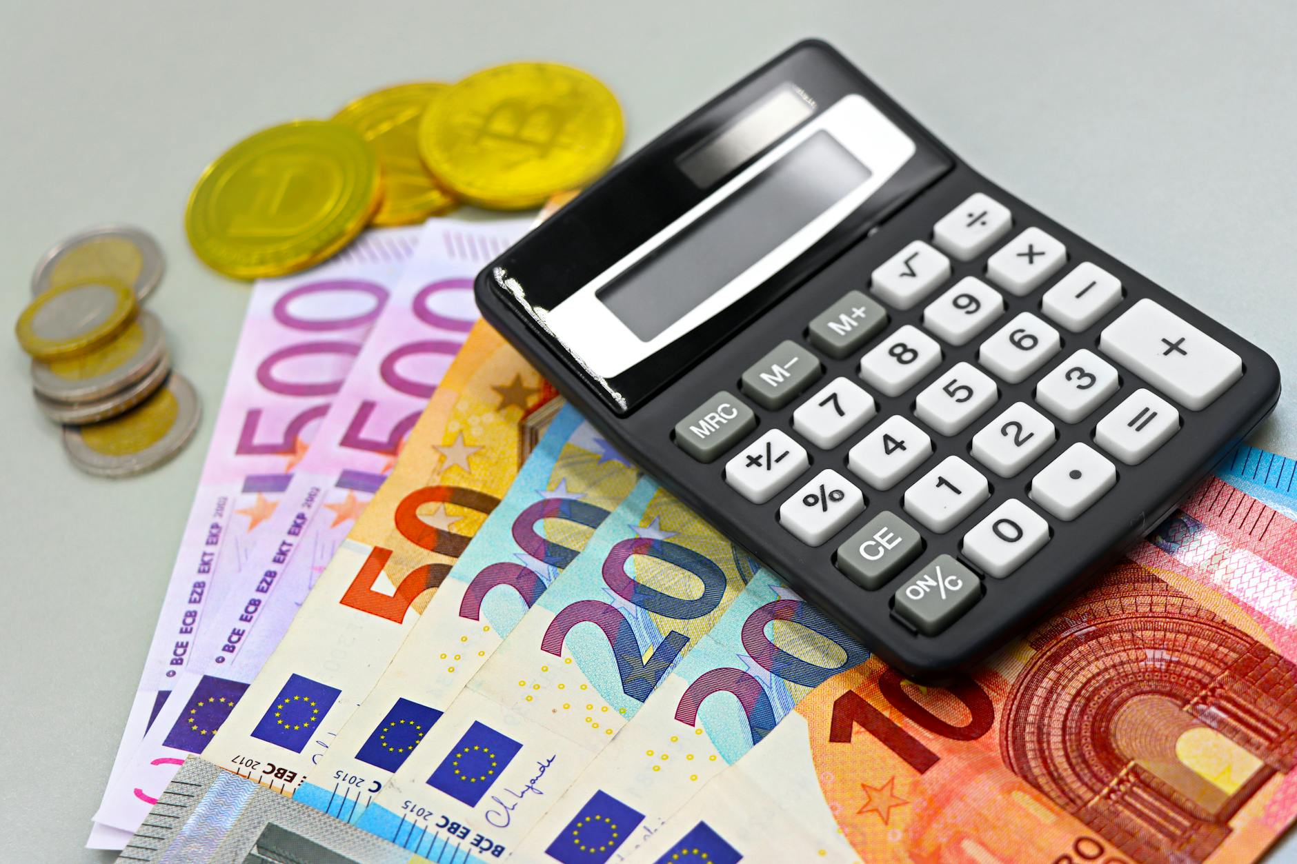 risparmio italiano — Image of euro banknotes, coins, and a calculator for financial planning. Perfect for finance themes.