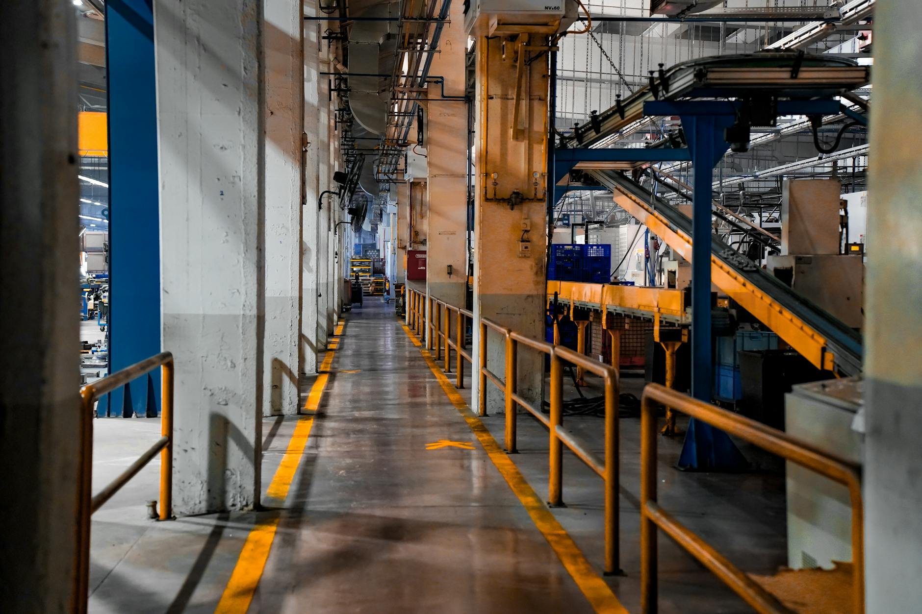 piano industriale Stellantis — Wide view of a modern factory interior showcasing industrial machinery and conveyor systems.