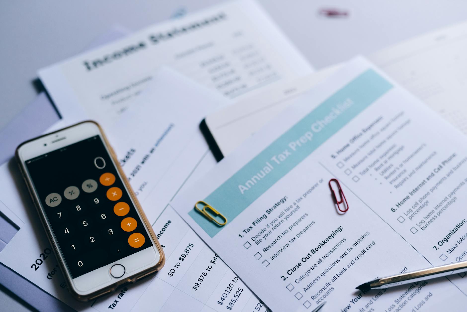 assistenza fiscale 730 — Tax preparation setup with documents, smartphone calculator, and checklist.