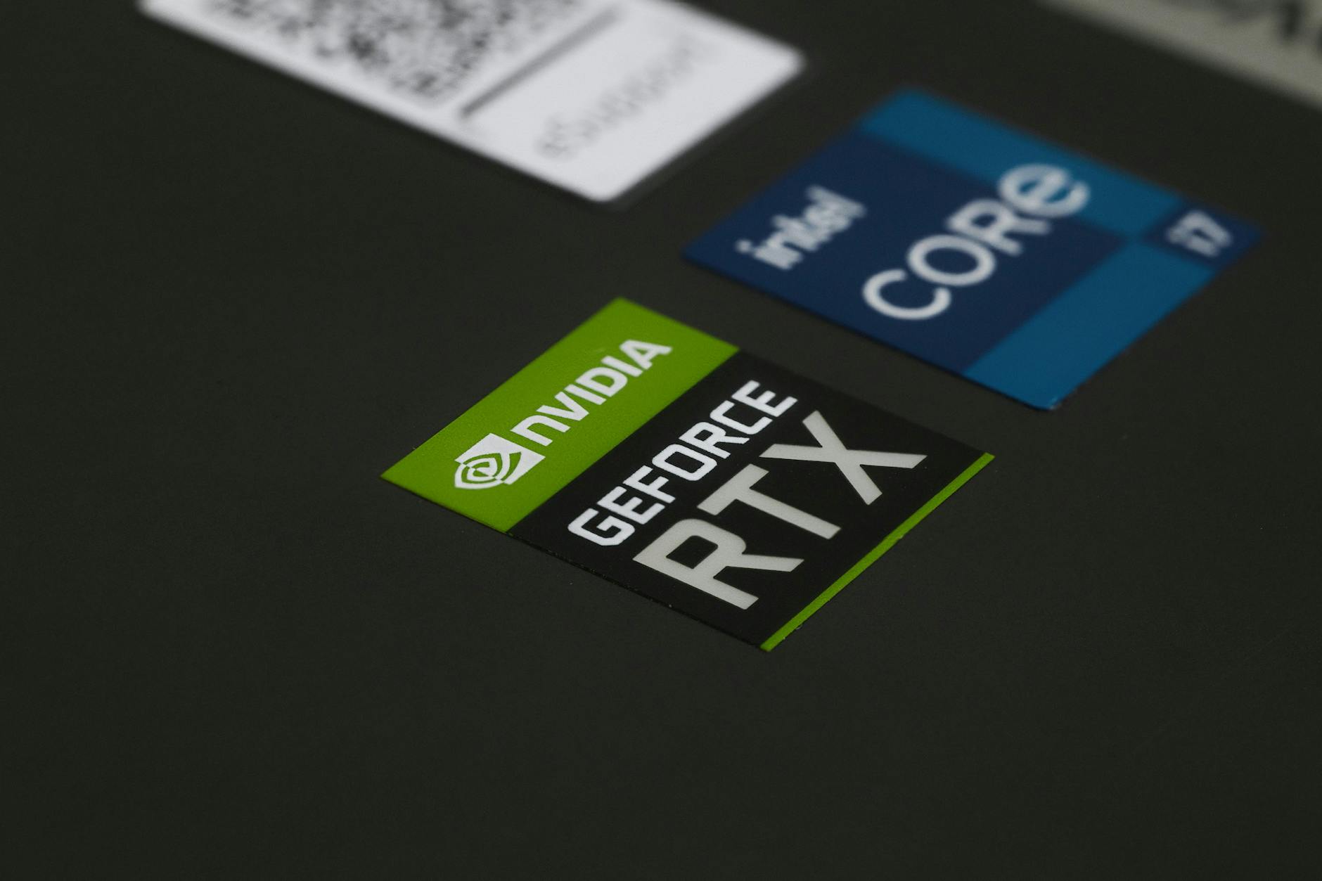 Nvidia RTX Spark — Close-up of NVIDIA GeForce RTX and Intel Core i7 stickers on a laptop surface, showcasing modern technology.